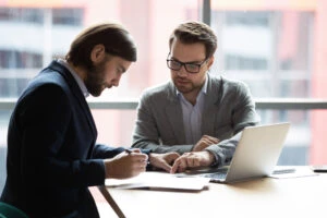 Lawyer sits at desk with client and explain how you prove wrongful death