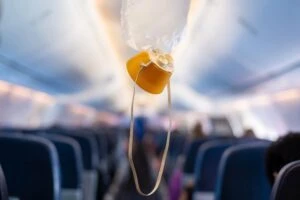 Oxygen mask drop from the ceiling compartment on airplane