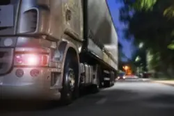A semi-truck driving at night in Los Angeles