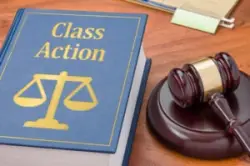 A book about class action is placed near a gavel. How long do class action lawsuits take?