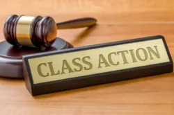 A name plate belonging to a mass tort and class action lawyer is placed near a gavel.