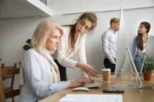 Young Team Leader Correcting Offended Senior