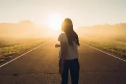 woman walking on an empty road