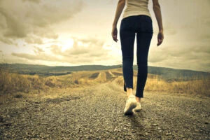 Woman walking alone on an empty street.