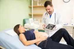 An Emeryville OBGYN shows a pregnant patient her ultrasound. Contact an Emeryville OBGYN malpractice lawyer.