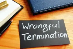 A note card reads ‘wrongful termination.’ Hire a Westchester wrongful termination lawyer now.