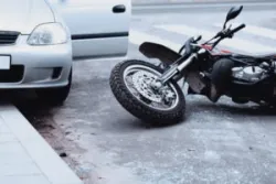 The photo depicts a motorcycle accident before an Oakland motorcycle accident lawyer is called onto the scene.