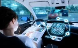 A woman sits in a self-driving car. How does someone determine liability in a self-driving car accident?