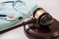 “What are the most common medical malpractice claims?”, someone asks while sitting at a desk with a gavel and stethoscope.