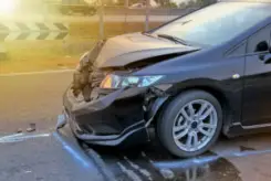 Image alt text: damaged front end of black car