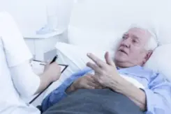 hospitalized male patient talking with nurse