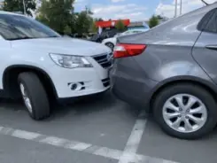 a car hitting another car in the parking lot