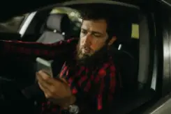 a man texting while driving