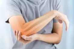 a person holding their fractured elbow