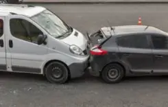 an suv hitting a compact car from behind