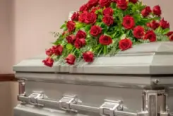 casket covered in roses