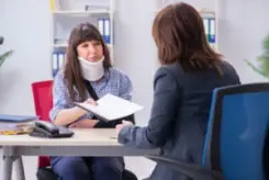 injured employee visiting with her lawyer