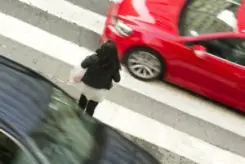 person entering a busy intersection