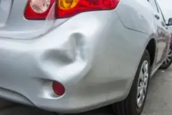 silver car damaged after a hit-and-run