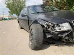 smashed black car after a head-on collision