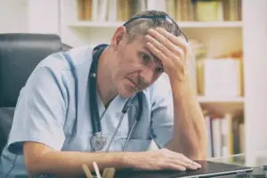 Depressed doctor feels stress. Augusta Medical Malpractice Lawyer
