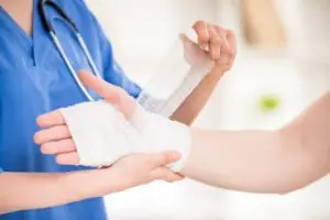 nurse bandaging a hand