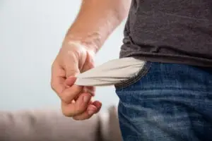 man pulling out empty pockets