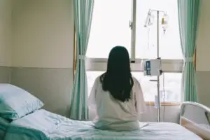woman sitting in a hospital bed