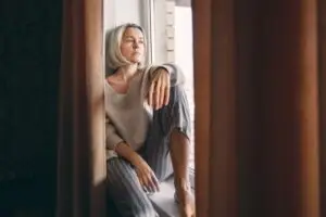 sad woman looking out a window