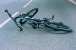 Bicycle lies on the pavement on the roadway. Concept on the theme of the accident.