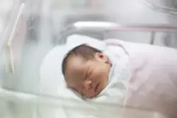 An infant in an incubator