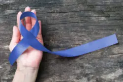 someone holding the blue ribbon for erbs palsy awareness