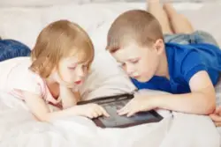 Two children looking at a tablet