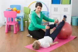 A child with Cerebral Palsy in physical therapy