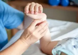 A physician checking a child's feet