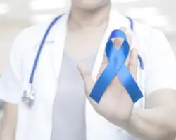 A nurse holding the cerebral palsy awareness ribbon