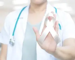A nurse holding a ribbon for Cerebral Palsy