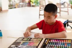 child with cerebral palsy drawing a picture