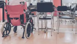 A wheelchair among other chairs in a cafateria