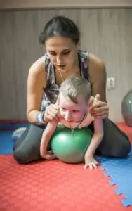 A child with cerebral palsy doing yoga