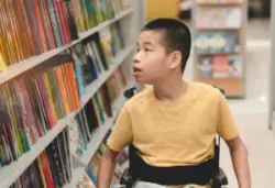 A child with cerebral palsy in a library