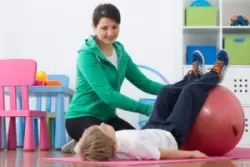 A child with erbs palsy working with a physical therapist