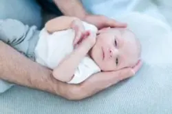baby in father’s arms