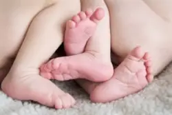 close-up of twin babies’ feet