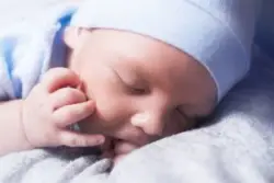 sleeping baby boy wearing a hat