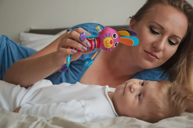 a mother plays with her baby with cerebral palsy