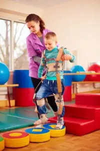boy undergoes musculoskeletal therapy in rehabilitation center