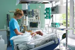 Nurse treats an infant in the hospital