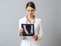 female physician examining x-rays for newborn baby