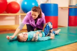 child diagnosed with cerebral palsy participating in physical therapy